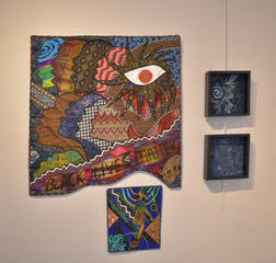 a photo of 4 pieces in the artquilt exhibit
